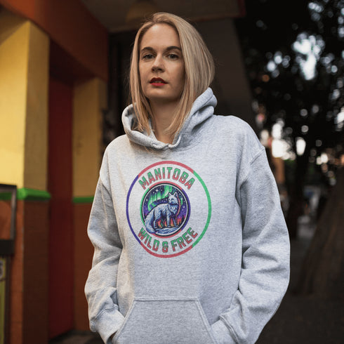 Unleash your wild side with our Manitoba – Wild & Free hoodie, featuring an enchanting graphic of an arctic fox beneath the dazzling northern lights.